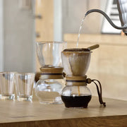 Hario Drip Pot with Olive Woodneck collar and reusable cloth filter for authentic Nel drip coffee brewing.