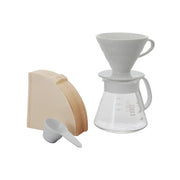 White ceramic Hario V60 pour-over set with a size 02 dripper for superior heat retention and a heatproof glass carafe.